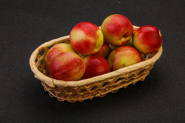 Sweet small nectarines in the basket