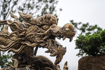 Colorful dragon sculpture at the entrance to a Buddhist temple in the city of Danang, Vietnam