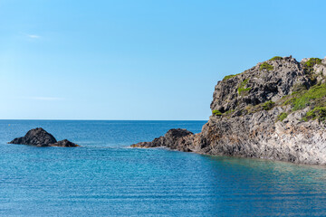 Fototapeta na wymiar Sea landscape with Cap de Creus, natural park. Eastern point of Spain, Girona province, Catalonia. Famous tourist destination in Costa Brava. Sunny summer day with blue sky and clouds