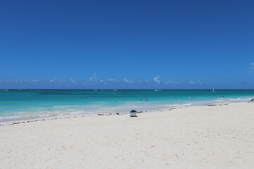 Fototapeta na wymiar White Sandy Beach with Blue Water