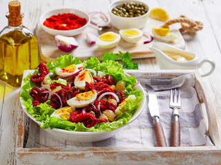 baby octopus salad with eggs, onion, lettuce
