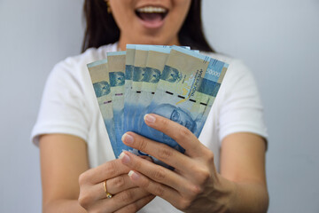 Woman Holding and Showing 50.000 Indonesian Rupiah Money