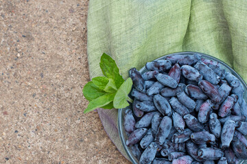 honeysuckle berries on a concrete background.