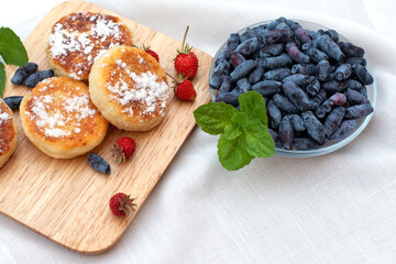 honeysuckle berries on a concrete background.