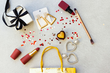 gift bag, lipsticks and beautiful earrings decorated with heart confetti and box