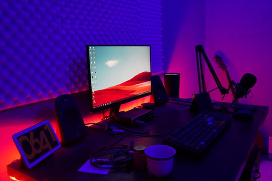 A Desktop Computer Setup With Colorful Lights Behind Desk