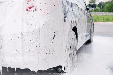 Car trunk in soapy foam from a detergent