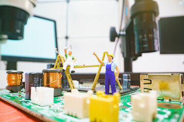 Miniature repair man on mainboard, Miniature figure of worker team try to repair cpu on mainboard.
