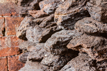 Dry charcoal pile stacked in basement