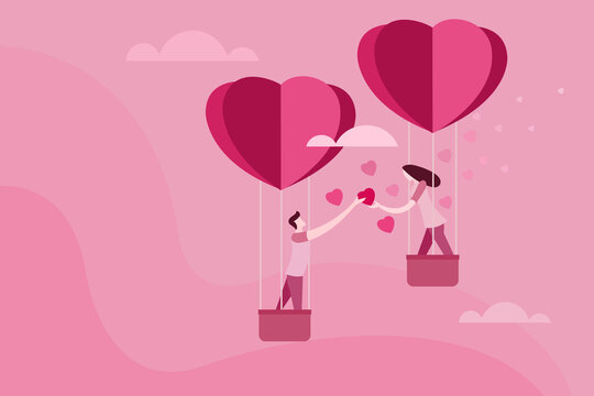 Couple in heart shaped balloons spreading love shapes. Concept for Valentines's day