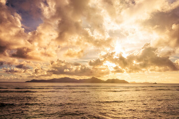 Beautiful Tropical  sunset with dramatic cloud and blue sky over sea and far island
