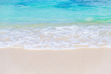 Fototapeta na wymiar Wave of blue ocean on sandy white beach. texture Background.