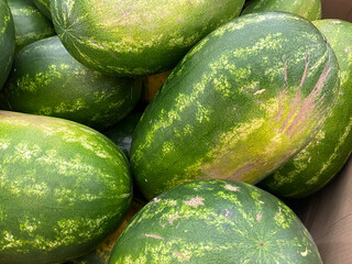View on isolated pile of green big watermelons in german supermarket