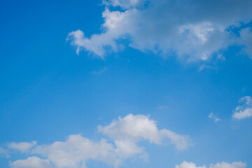 Soft white clouds against blue sky background.