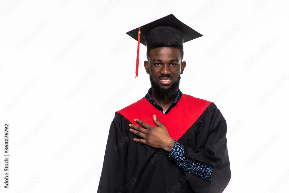 Wall mural Excited young graduation african man with hands on heart isolated on white background