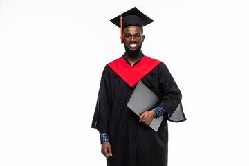 African man student in graduate robe with laptop over white background