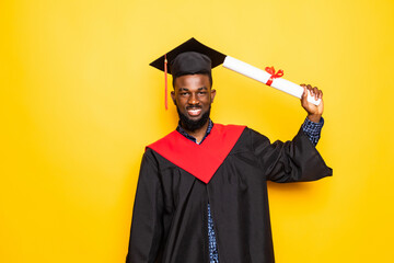 African American man college graduate with diploma isolated on yellow background