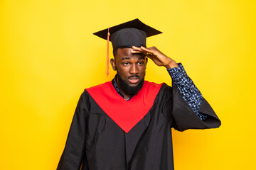 African American man college graduate isolated on yellow background