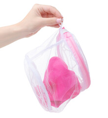Pink laundry bag for underwear in hand on white background isolation