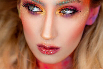 Bright makeup and face art, close-up portrait. Creative makeup,