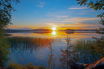 Warm summer sunset at the lake of the woods