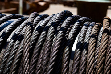 Fototapeta na wymiar steel rope wrapped around reel in port. ship and marine concept background.