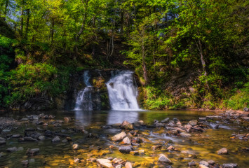 wonderful waterfall on the mountain river Carpathians. Gurkalo or Hurkalo Waterfall, Carpathian Mountains, National Park of Skole Beskydy, Ukraine. June 2020. Long exposure shot.