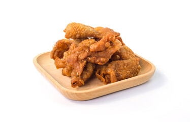 Crispy fried chicken skins on wooden plate. Fried chicken skin on white background. Snack and Appetizers