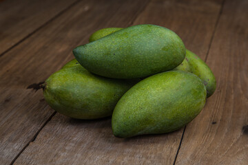 Fresh green mango on wooden table. Tropical fruit. mangoes on wooden background
