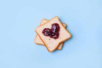 Bread toast with jam heart shaped  on a blue background