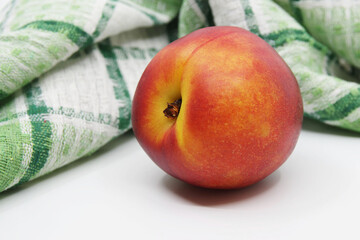 Nectarine on white background. Nectarine fruit isolated on white background. Kitchen towel