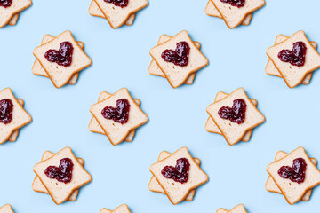 Bread toast with jam heart shaped  on a blue background seamless pattern