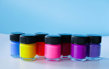 Colors Poster bottle on blue background color paint cans