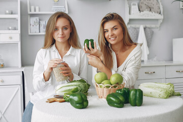 Healthy eating. Dieting and people concept. Blonde with a vegetable. Friends sitting on a kitchen