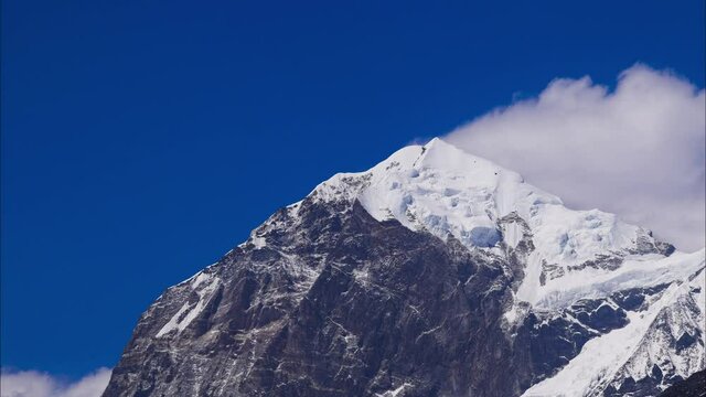 Time-lapse of Clouds forming above the glacial Mountain Peak Mt. Pandim at an elevation of 6691m shot in 4k