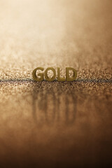 Fototapeta na wymiar Alphabet gold word block with gold background. 3D rendering.