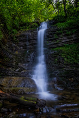 Fototapeta na wymiar Laznyi waterfall is located in Ukrainian Carpathians at the summer times, july 2020. Long exposure shot.