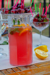 raspberry mojito drink in jar, cherry blurred background