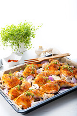 Prepared chicken legs with various vegetables and herbs