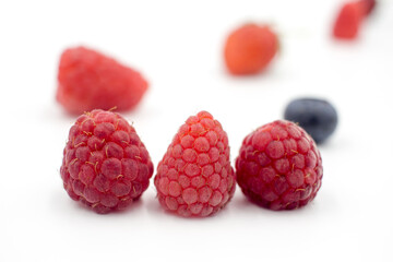 Delicious summer berries: blueberries, strawberries, raspberries on a white background, close-up