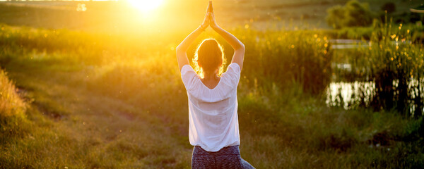 woman in a yoga pose at sunset by lakeside mindfulness and mental health