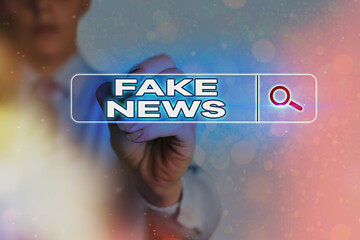 Writing note showing Fake News. Business concept for false information publish under the guise of...