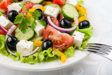 Greek salad on the white plate