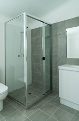 New compact modern bathroom with shower recess and vanity basin