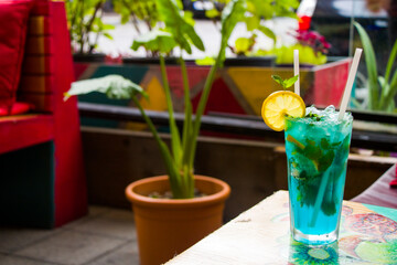 Blue cocktail with curacao and citruses. Alcoholic drink. Summer holidays.