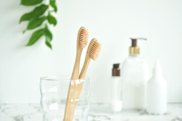 Bamboo toothbrush, soap and green leafs Biodegradable personal care products. No plastic