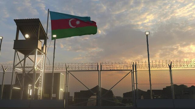 Flying flag of Azerbaijan above military base in the evening