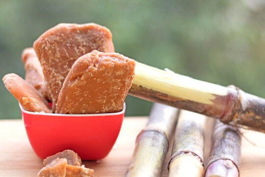 Raw sugarcane, organic Jaggery and white processed sugar in one frame