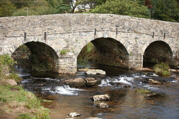 Fototapeta na wymiar Stone bridges near Moretonhampstead a market town, parish and ancient manor in Devon, situated on the north-eastern edge of Dartmoor, within the Dartmoor National Park.