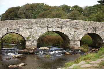 Fototapeta na wymiar Stone bridges near Moretonhampstead a market town, parish and ancient manor in Devon, situated on the north-eastern edge of Dartmoor, within the Dartmoor National Park.